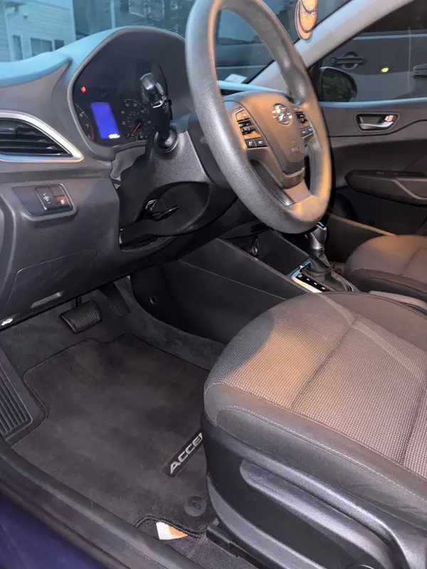 Hyundai Accent driver area after: clean mat, wiped dash and seat